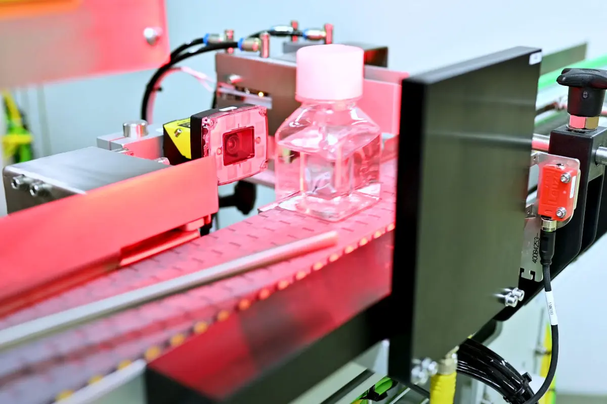Glass bottle being scanned for labelling errors