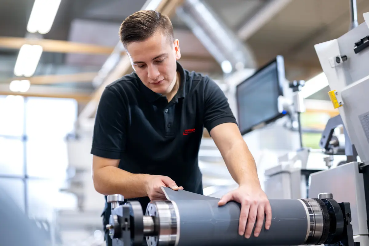 Trainee installing label roll to print labels